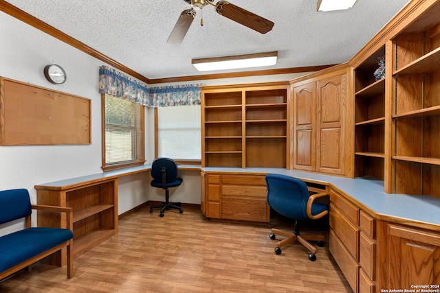 office featuring ceiling fan, a textured ceiling, built in desk, and light hardwood / wood-style floors