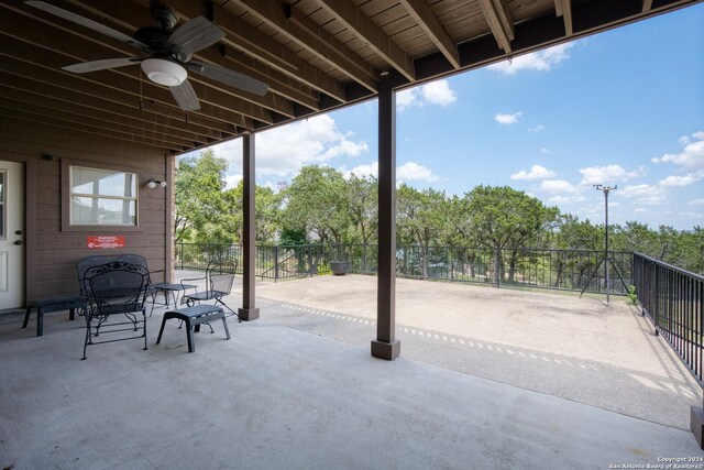 view of patio featuring ceiling fan and fence