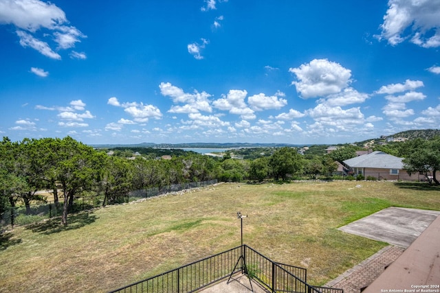 view of yard with a water view and fence