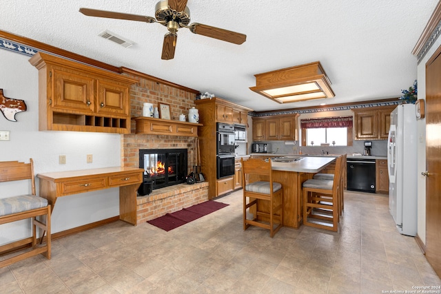 kitchen with black appliances, light tile patterned floors, a brick fireplace, and ceiling fan