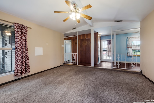 unfurnished room with ceiling fan, carpet, and vaulted ceiling with beams