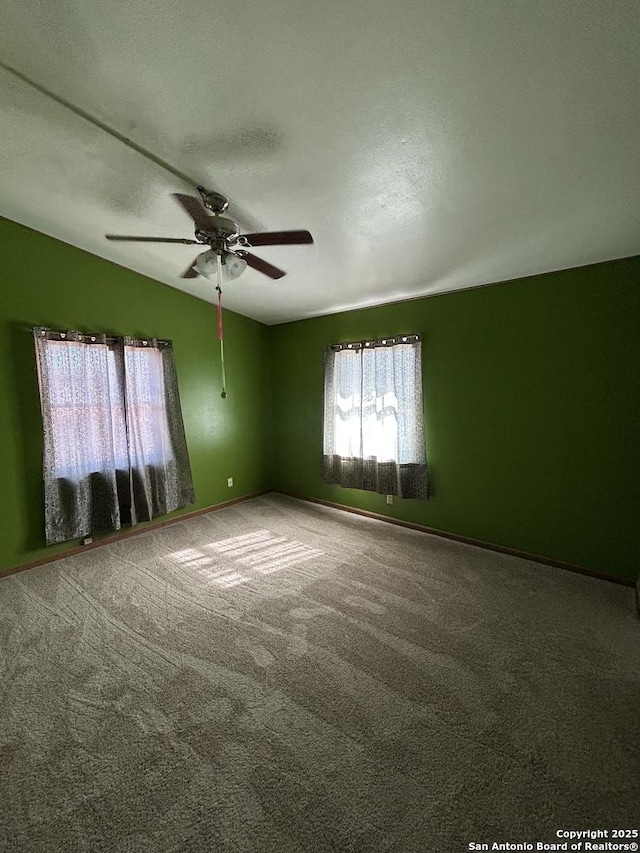 carpeted empty room with ceiling fan