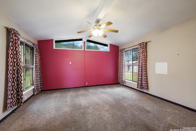 carpeted empty room featuring ceiling fan and lofted ceiling with beams