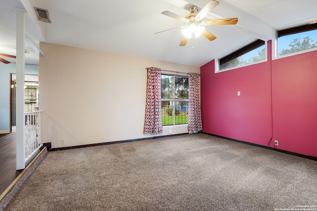 empty room featuring vaulted ceiling with beams, ceiling fan, and carpet