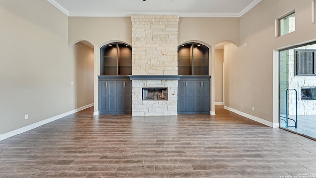 unfurnished living room featuring a fireplace and crown molding