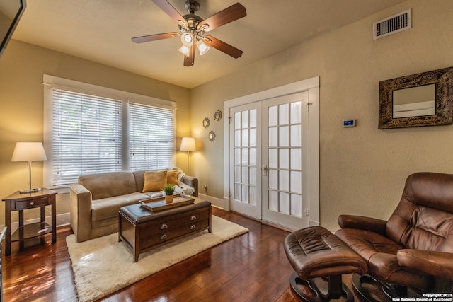 living room featuring ceiling fan, french doors, and dark hardwood / wood-style floors