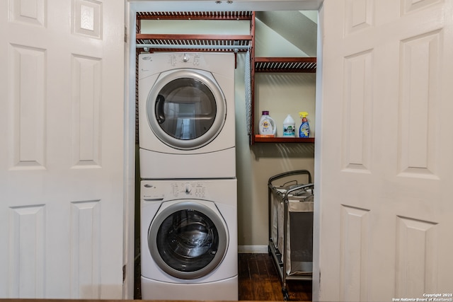 laundry room featuring dark hardwood / wood-style flooring and stacked washer and clothes dryer