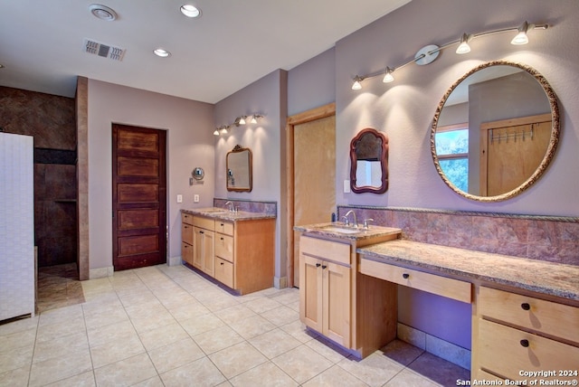 bathroom with tile patterned flooring and vanity