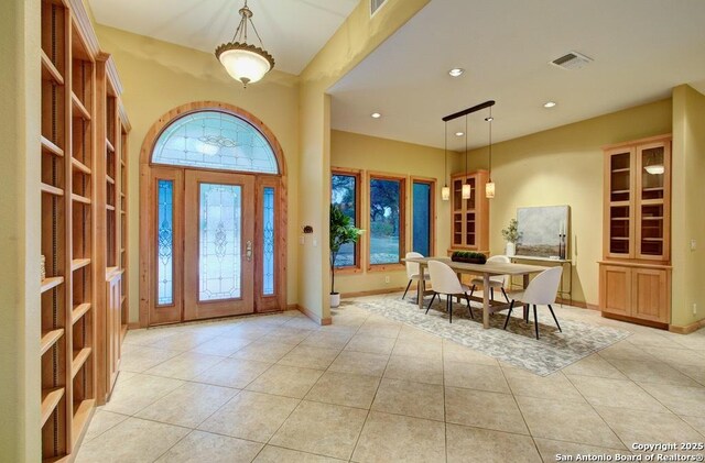 foyer entrance with light tile patterned flooring