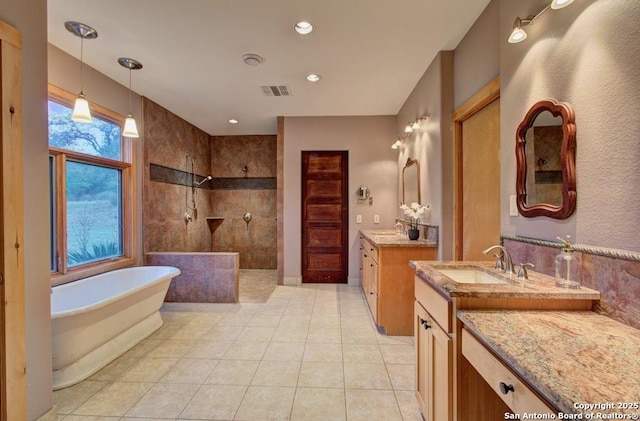 bathroom with vanity, independent shower and bath, and tile patterned flooring