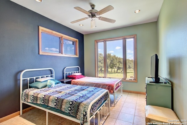 tiled bedroom featuring ceiling fan