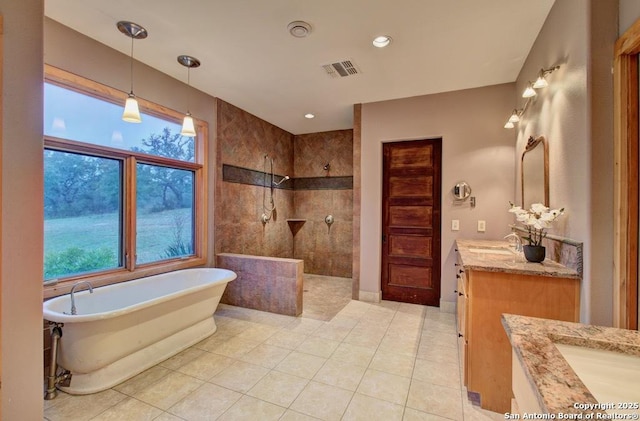 bathroom with tile patterned floors, vanity, and plus walk in shower