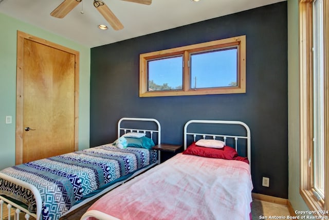 carpeted bedroom featuring ceiling fan