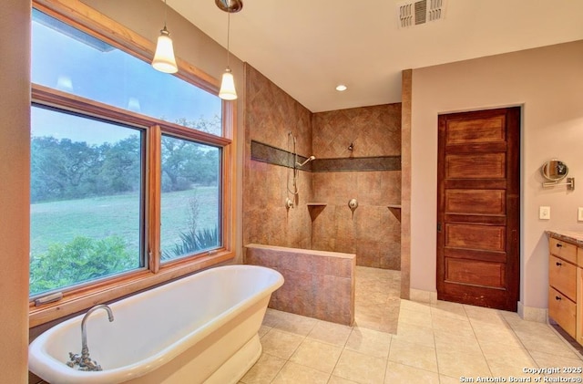 bathroom with plenty of natural light, vanity, shower with separate bathtub, and tile patterned flooring