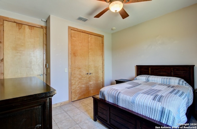 bedroom with ceiling fan and light tile patterned floors