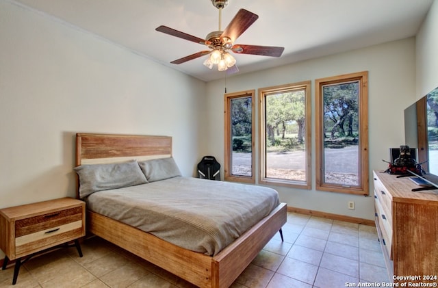 tiled bedroom with ceiling fan