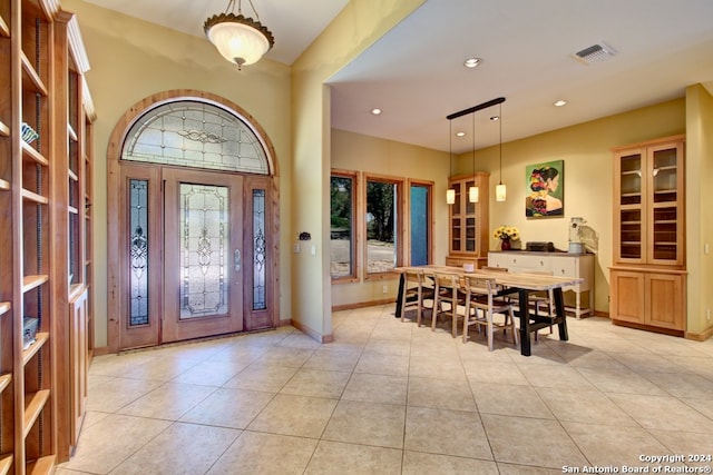 foyer entrance featuring light tile patterned floors and a wealth of natural light