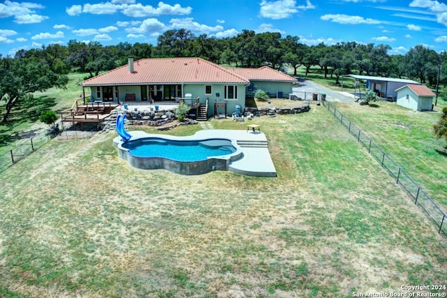 view of swimming pool featuring a wooden deck and a water slide