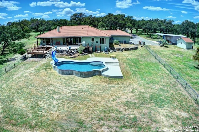 view of pool with a lawn