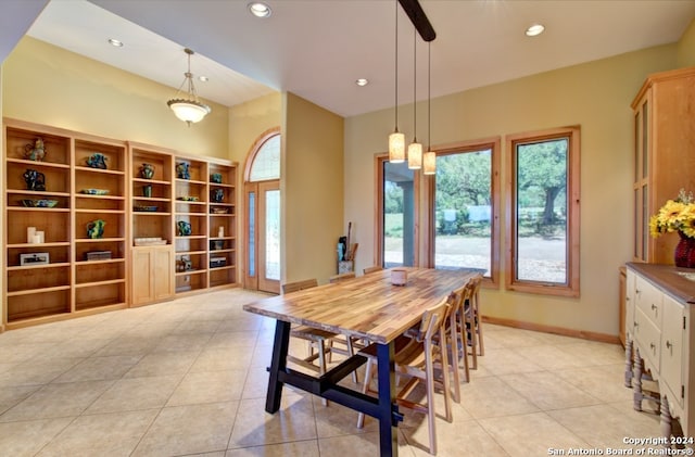 dining space featuring light tile patterned floors and a healthy amount of sunlight