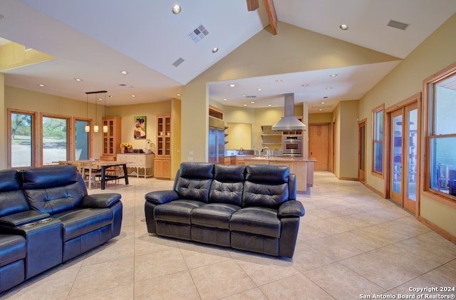 living room featuring beam ceiling, sink, high vaulted ceiling, and light tile patterned flooring