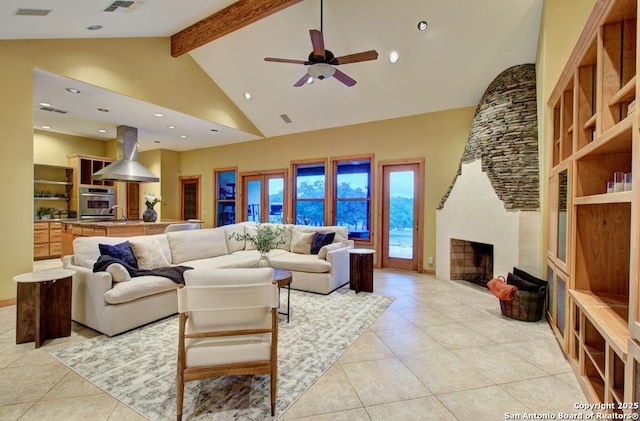 tiled living room featuring a fireplace, beamed ceiling, high vaulted ceiling, and ceiling fan