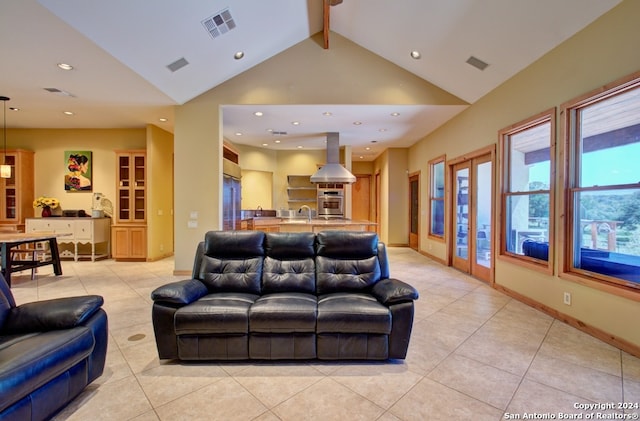 tiled living room featuring vaulted ceiling with beams and sink