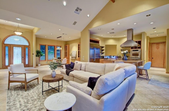 tiled living room with high vaulted ceiling and sink