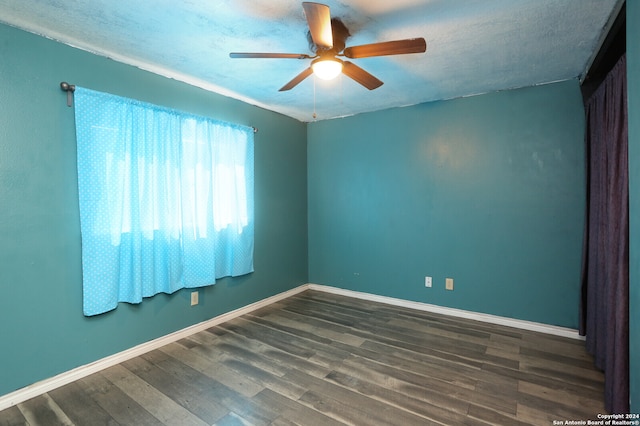 spare room featuring ceiling fan, wood-type flooring, and a textured ceiling