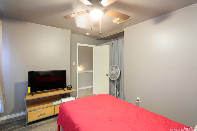 bedroom featuring ceiling fan and hardwood / wood-style flooring