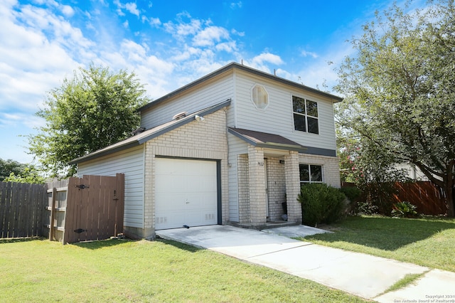 view of front of home with a front yard and a garage