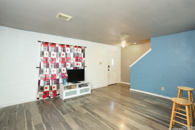 unfurnished living room featuring wood-type flooring