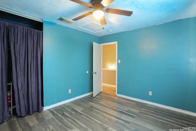 empty room with a textured ceiling, hardwood / wood-style floors, and ceiling fan