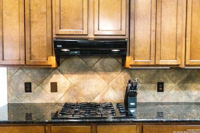 kitchen with range hood, tasteful backsplash, and gas stovetop