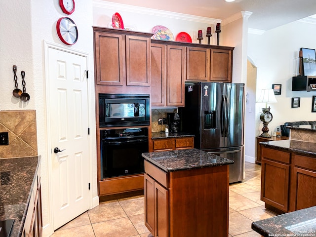 kitchen with decorative backsplash, light tile patterned flooring, ornamental molding, black appliances, and a center island