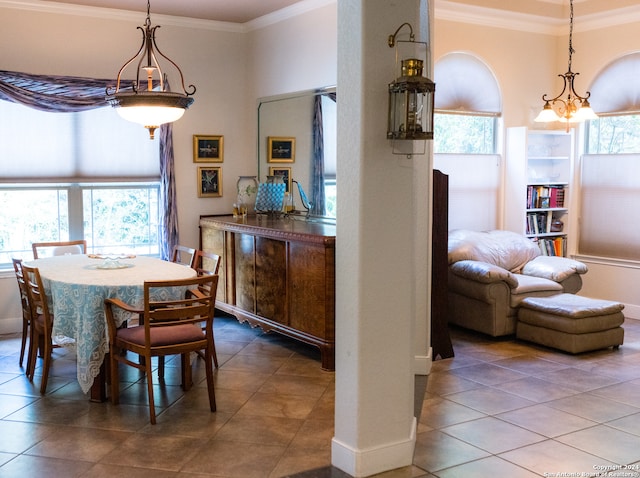 tiled dining space with crown molding and plenty of natural light