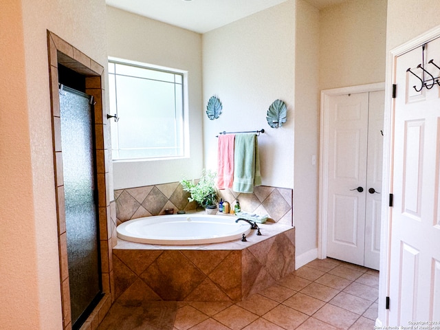 bathroom featuring plus walk in shower and tile patterned floors