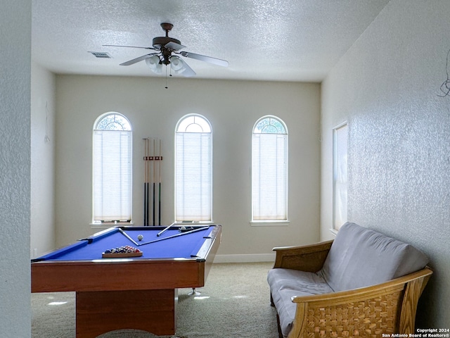 playroom featuring ceiling fan, pool table, a textured ceiling, and light colored carpet