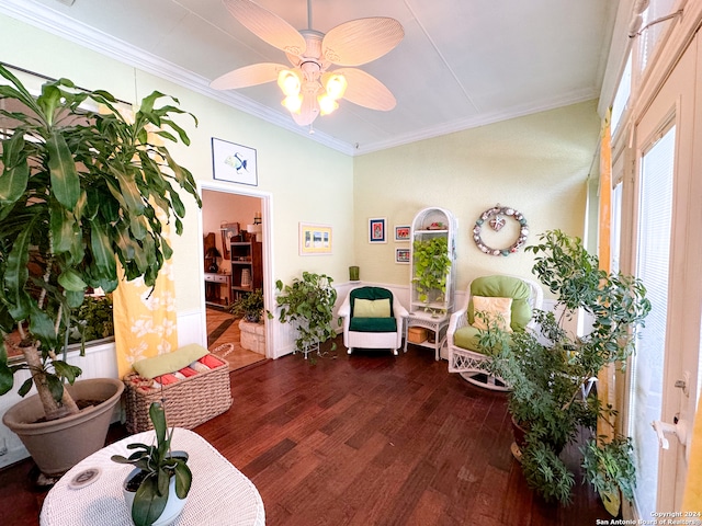 interior space with ceiling fan, ornamental molding, and hardwood / wood-style floors