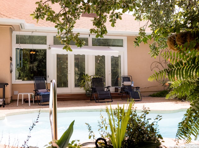 view of pool with a patio and french doors