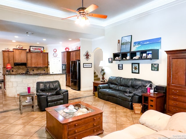 living room with ceiling fan, light tile patterned floors, and crown molding