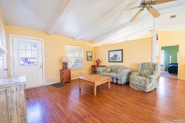 living room with ceiling fan, plenty of natural light, lofted ceiling with beams, and hardwood / wood-style flooring