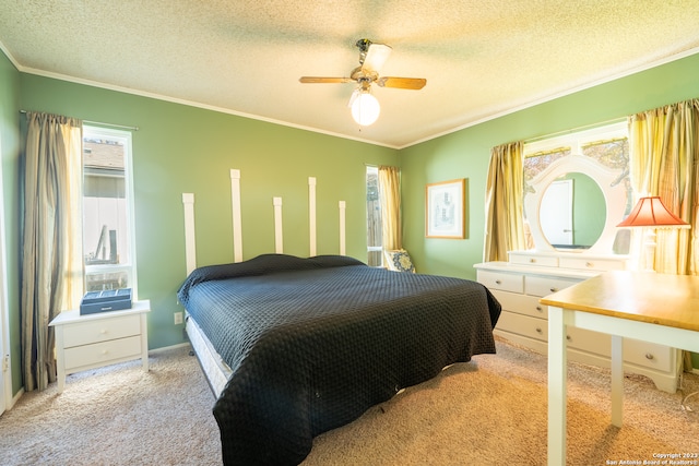 bedroom featuring ceiling fan, a textured ceiling, crown molding, and light colored carpet