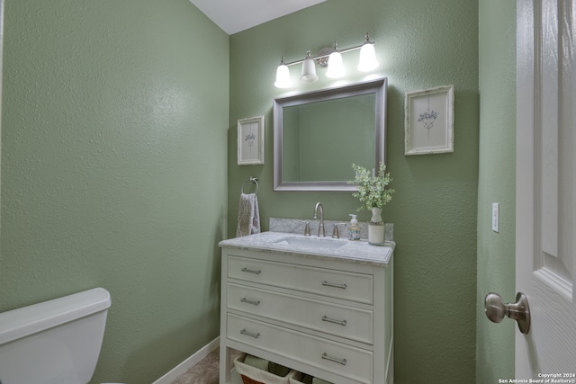 bathroom with vanity, toilet, and tile patterned flooring