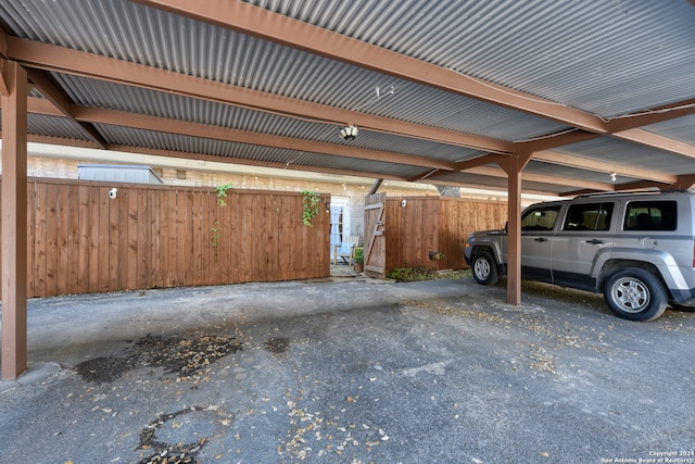 garage with wood walls and a carport