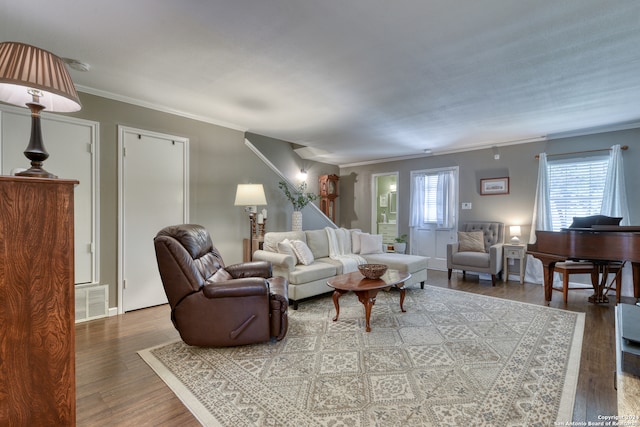 living room featuring crown molding, hardwood / wood-style flooring, and a wealth of natural light