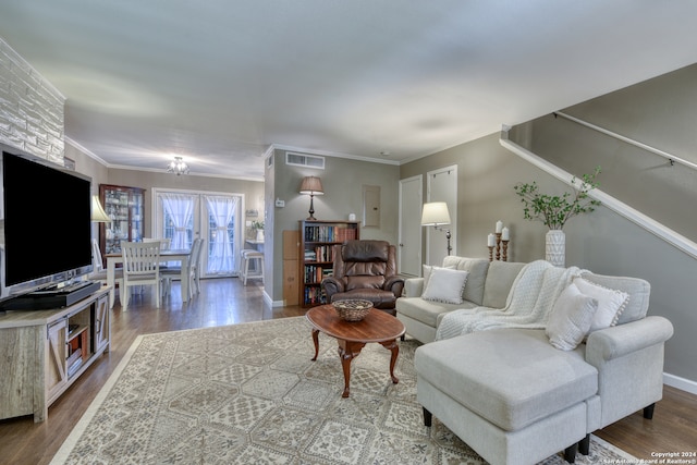 living room with hardwood / wood-style floors and ornamental molding