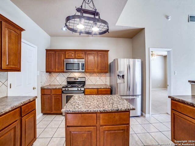 unfurnished bedroom with ensuite bathroom, ceiling fan, and light colored carpet