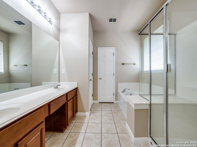 bathroom featuring tile patterned flooring, vanity, and shower with separate bathtub