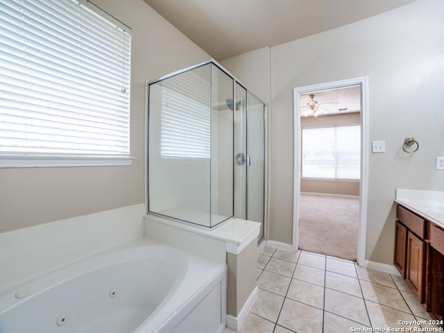 bathroom featuring tile patterned flooring, vanity, and separate shower and tub